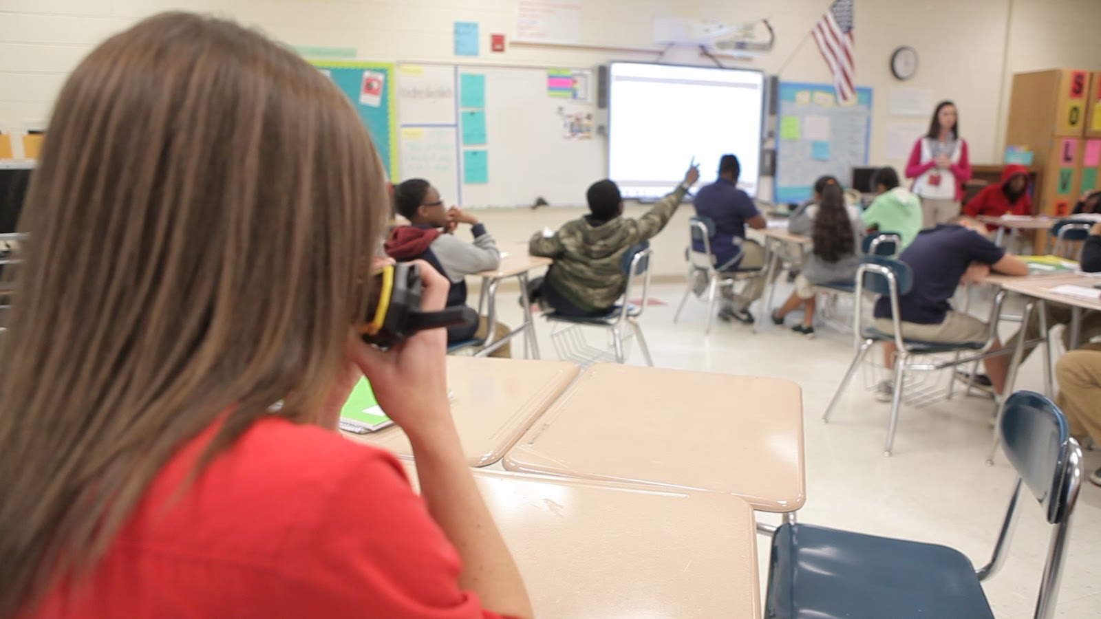 Instructional coach using a walkie talkie to do real time teacher coaching