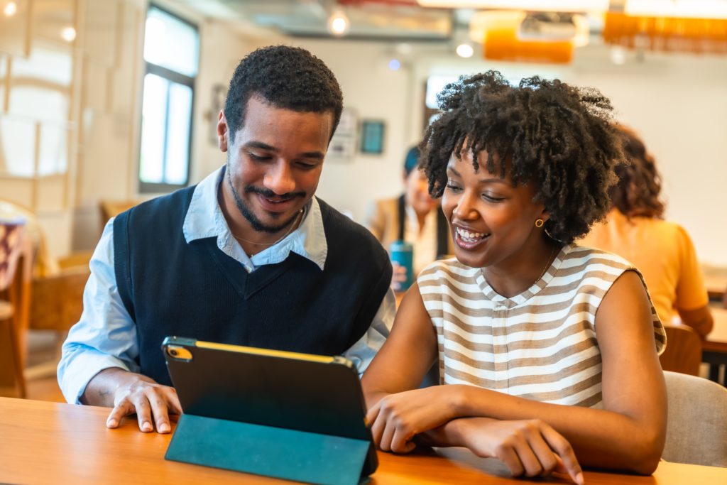 Two teachers looking at instructional coaching software on a tablet